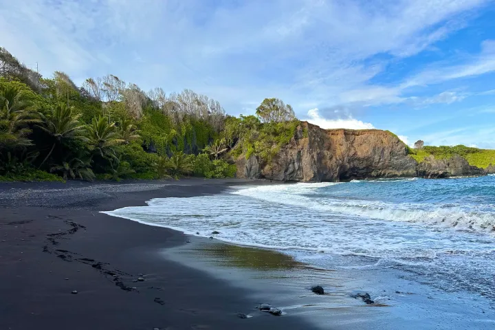a body of water with a mountain in the background