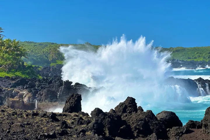 a man riding a wave on top of a mountain