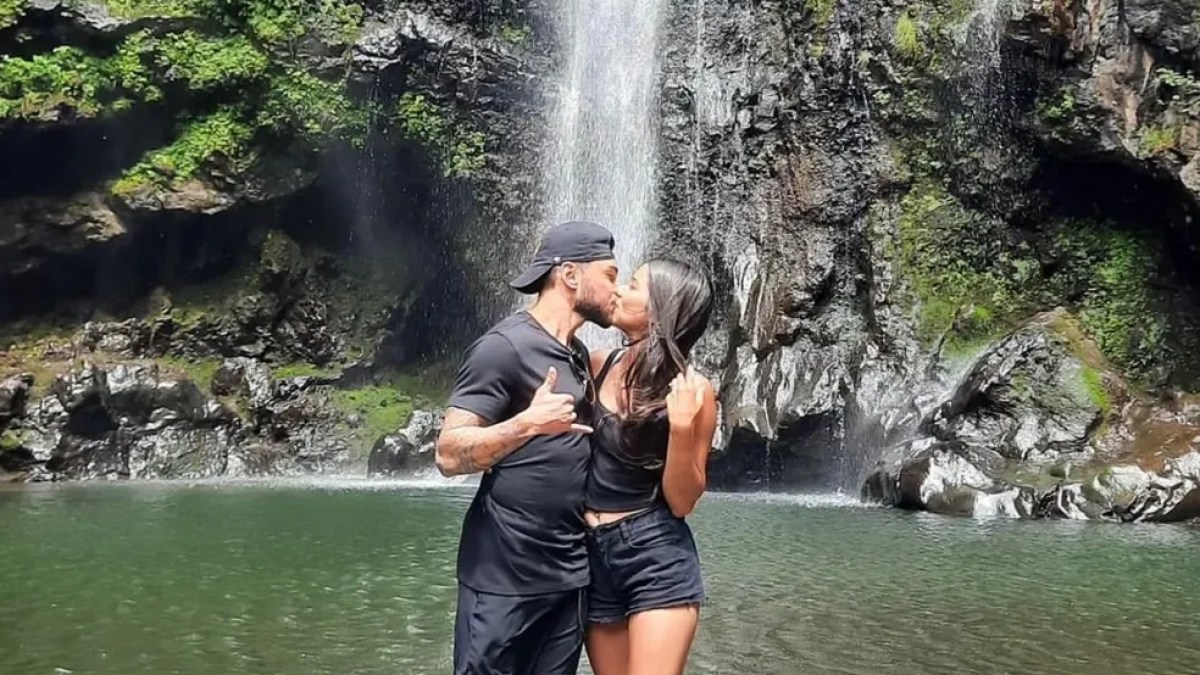 A couple kissing under a waterfall in in Maui, Hawaii