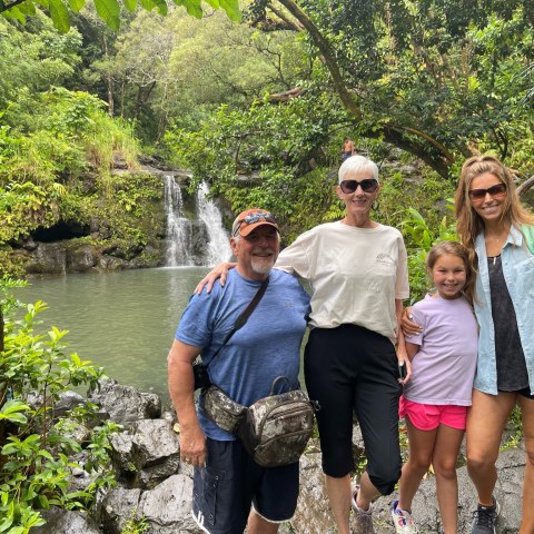 a group of people standing next to a river