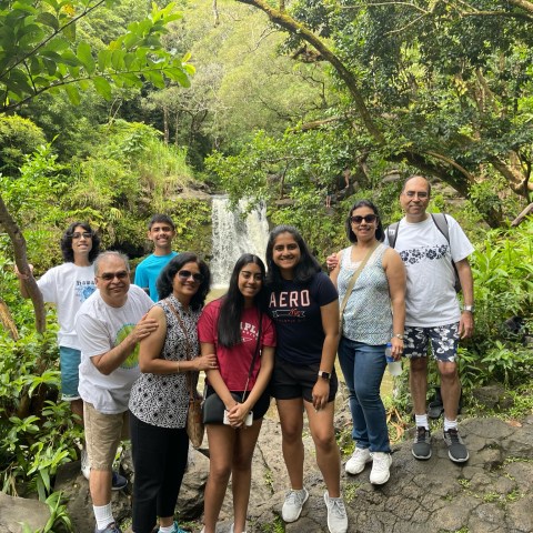 a group of people standing next to a tree