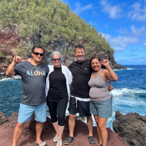 a group of people standing next to a body of water