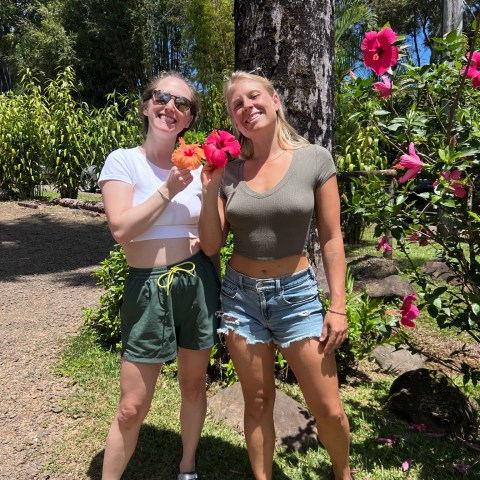 a little girl standing in a garden