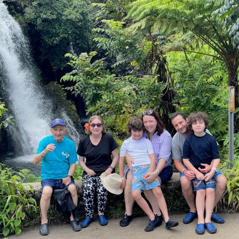 a group of people standing next to a tree