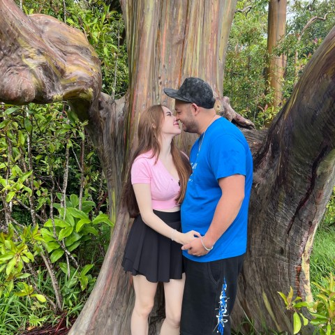 a person standing next to a tree