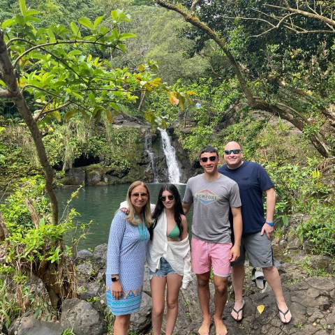 a group of people standing next to a tree