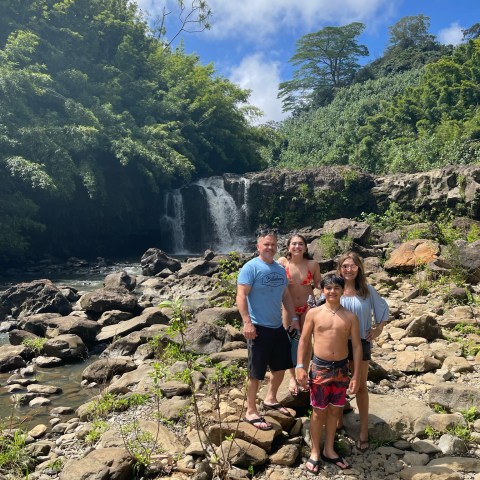 a group of people standing on a rock