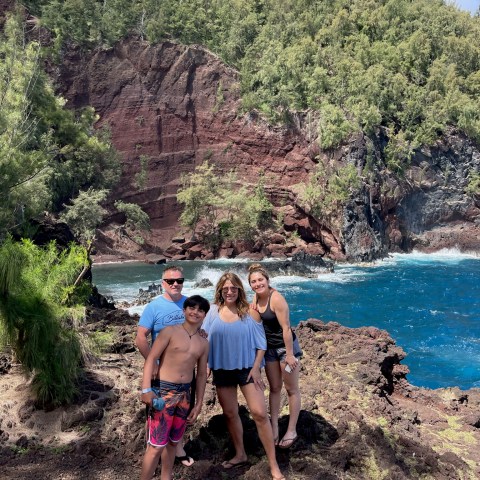 a group of people standing on a beach