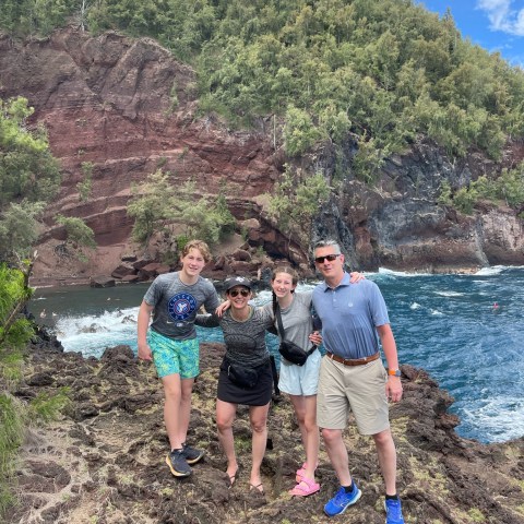 a group of people standing next to a tree