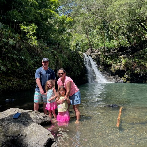 a group of people standing next to a river