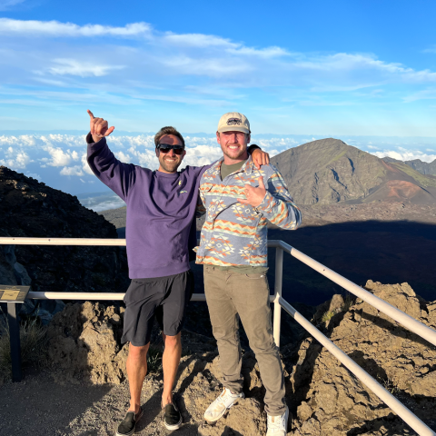a group of people posing for a photo in front of a mountain