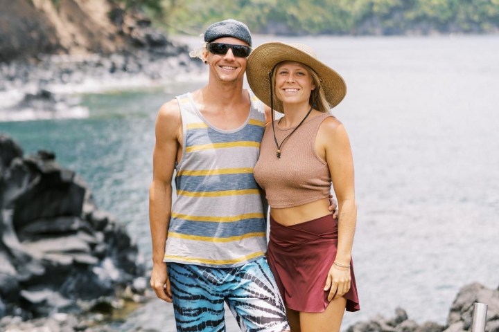 a person standing on a beach near a body of water