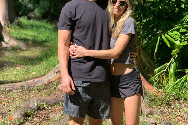 a person standing next to a forest