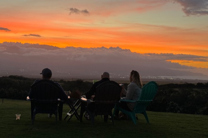 a group of people at sunset